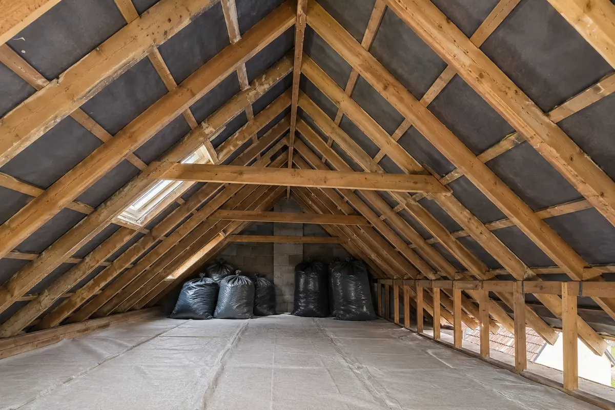 UK loft after spray foam removal with timber rafters clearly visible for inspection